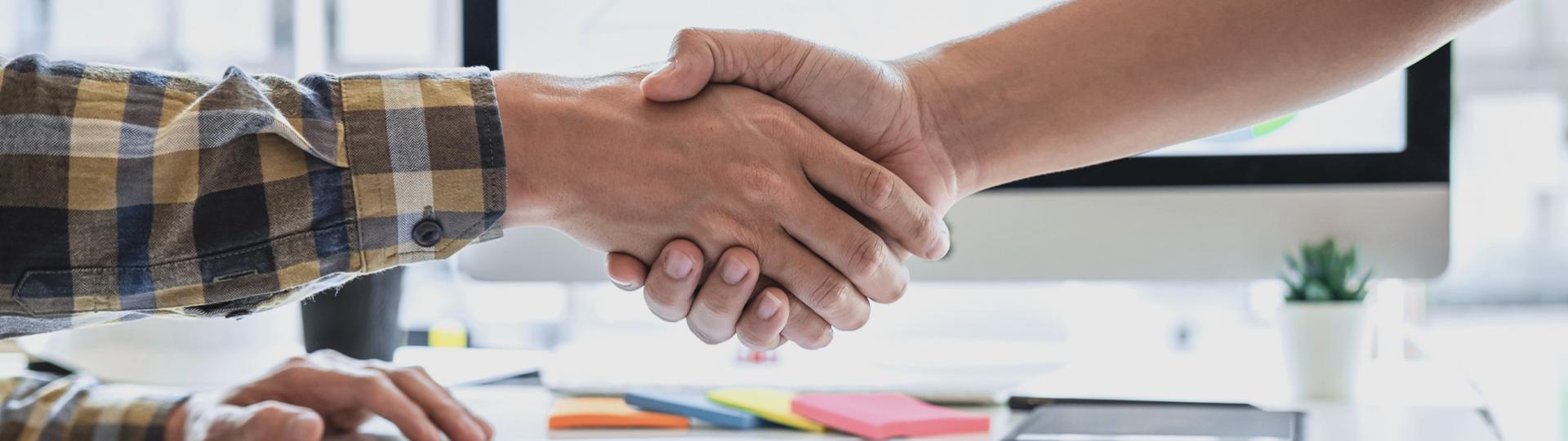 shaking hands above a table